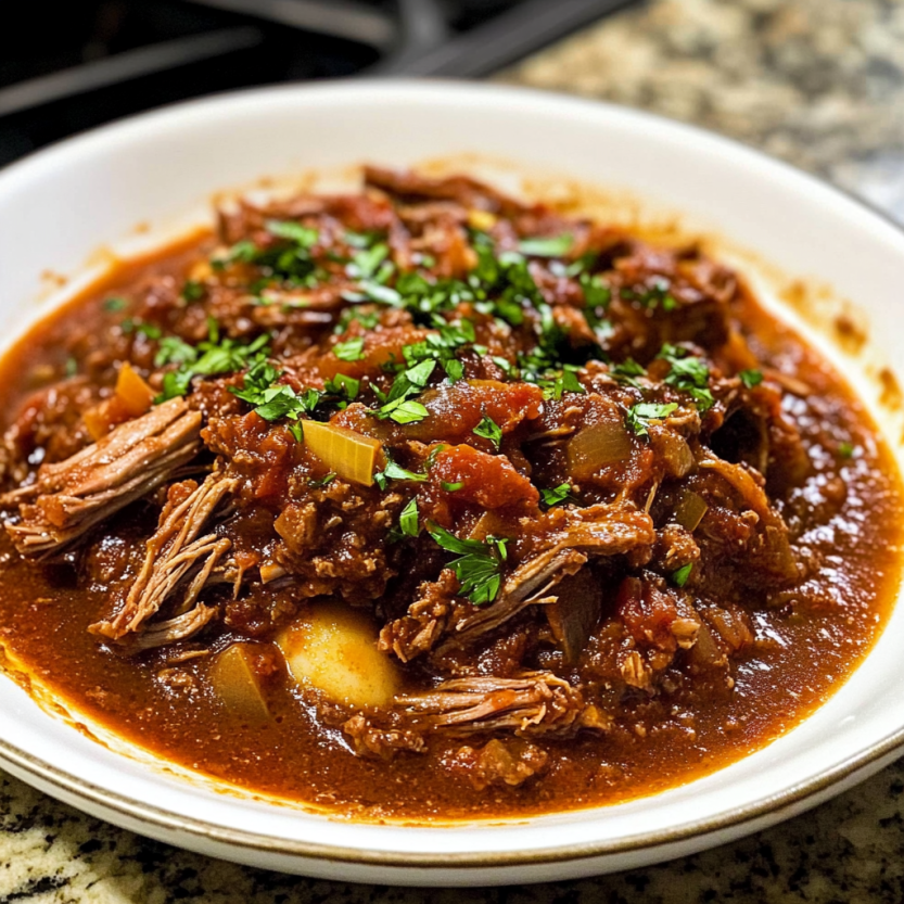 A plate with Short Rib Ragu on a table.