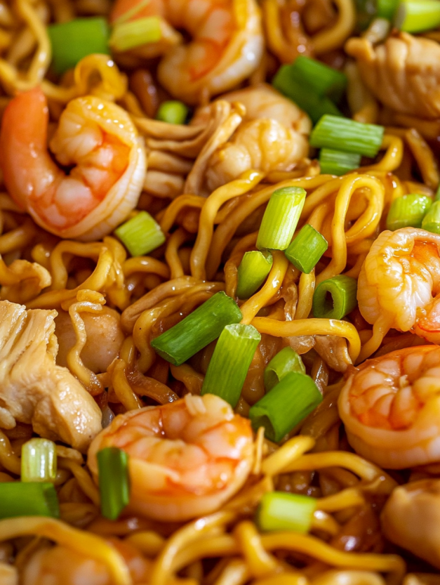 A plate of shrimp and chicken chow mein.