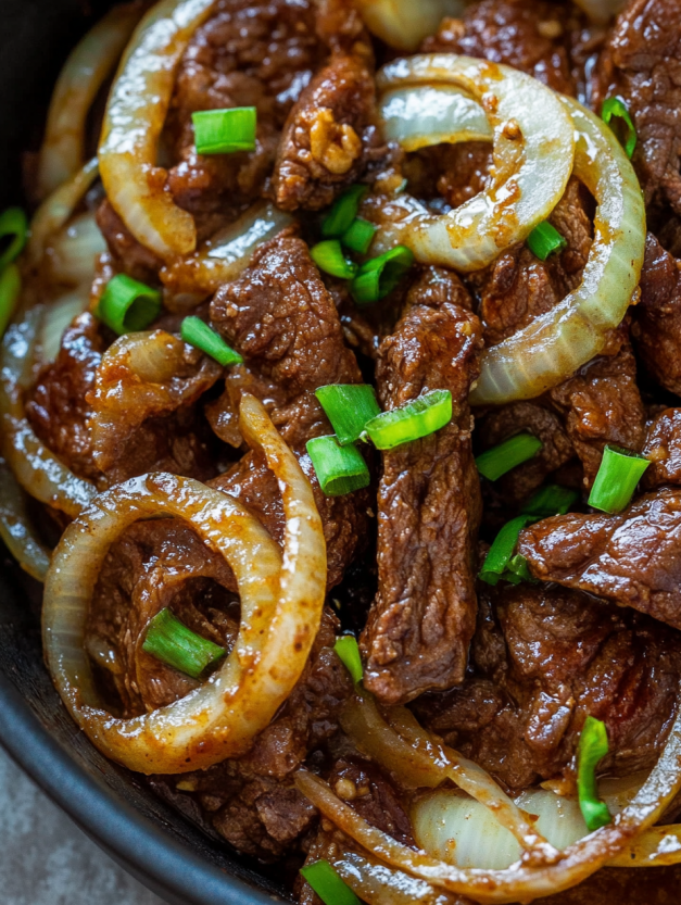 A bowl of beef and onions.