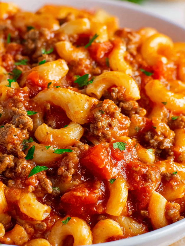 A close up of a crock pot filled with American goulash.