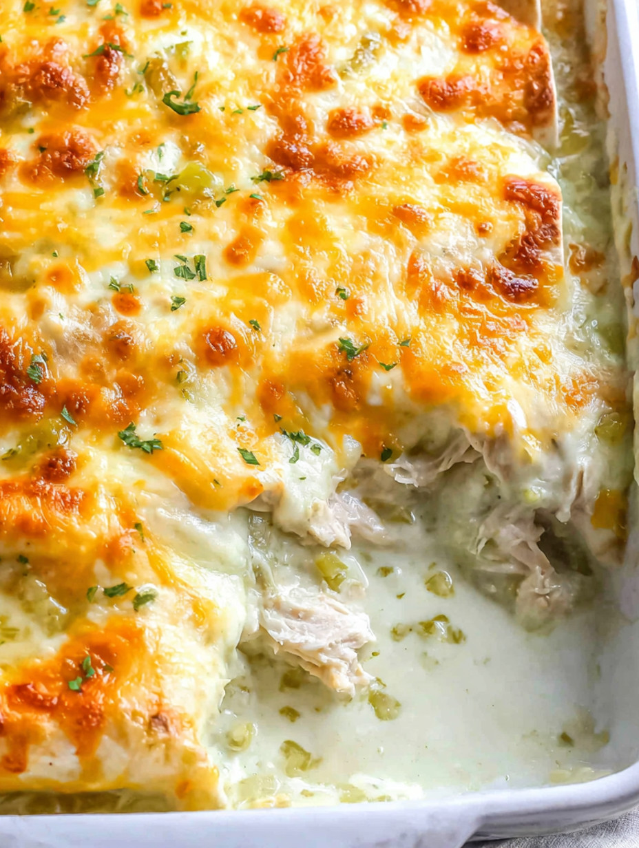A close up of a creamy white chicken enchilada.