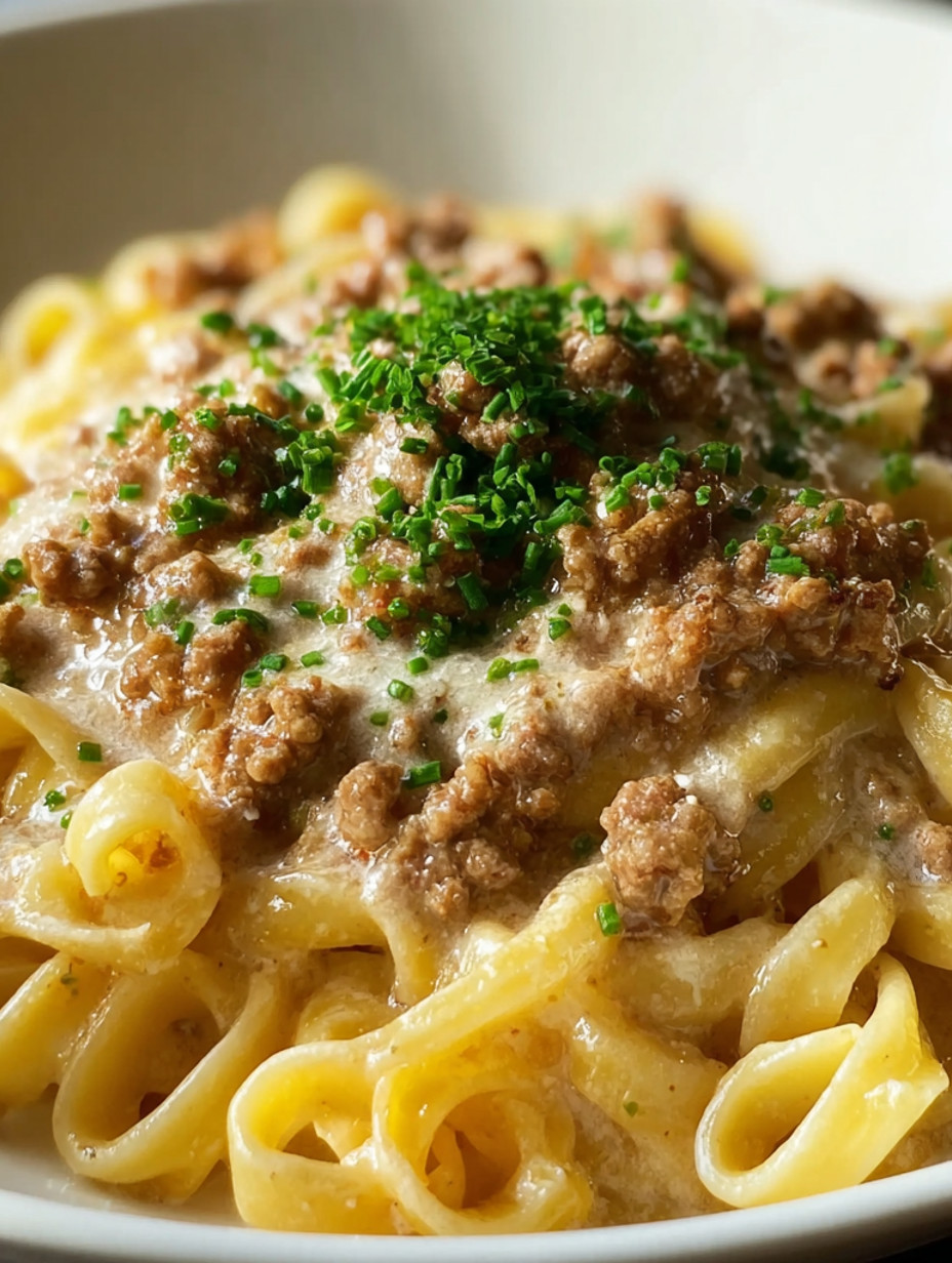 A delicious plate of pasta with a rich white bolognese sauce.