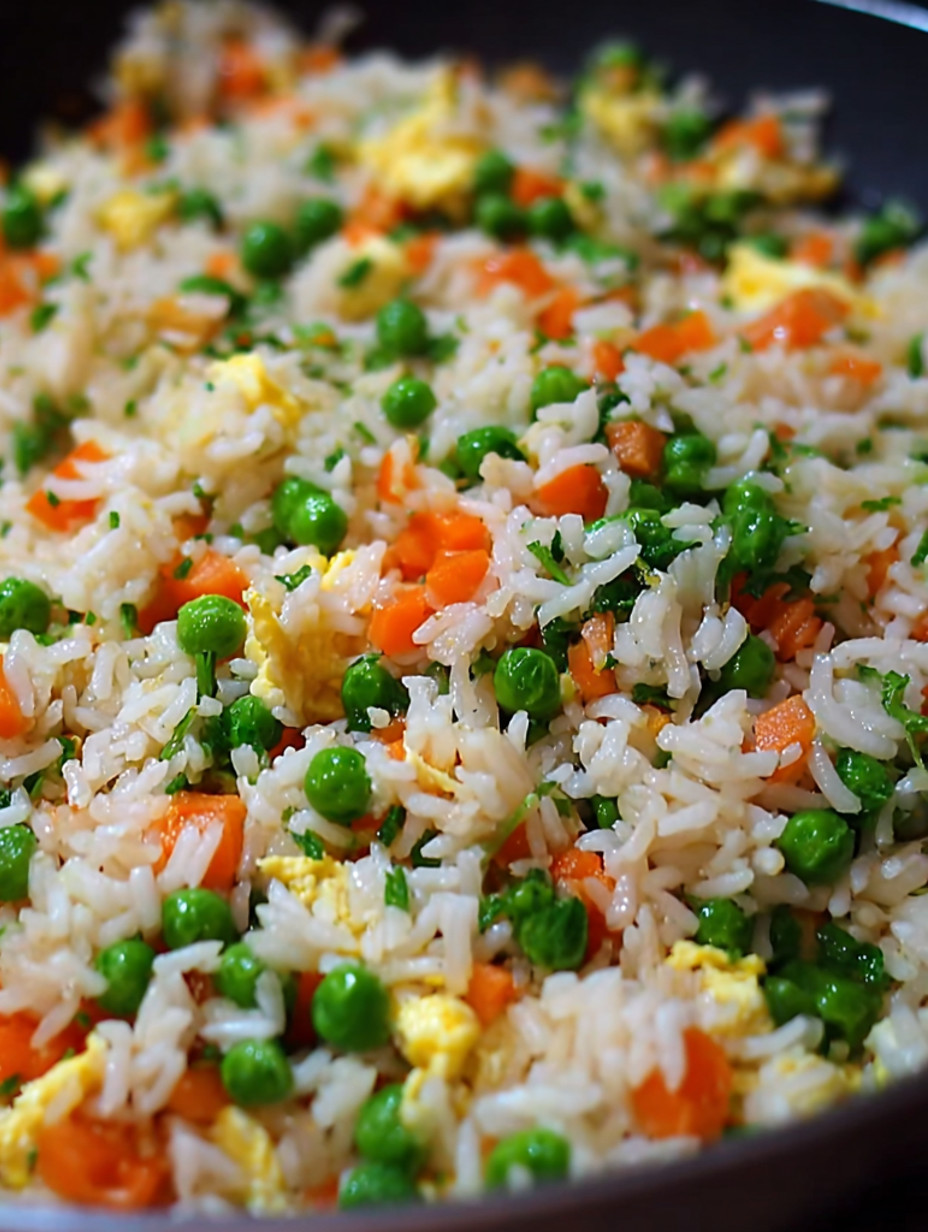 A close up of a plate of egg fried rice.