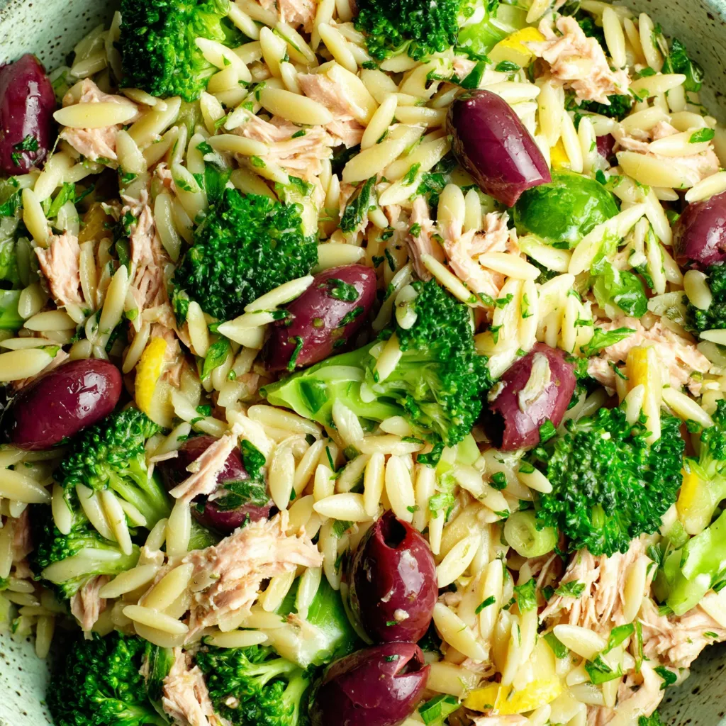 A bowl of food with broccoli, rice, and olives.