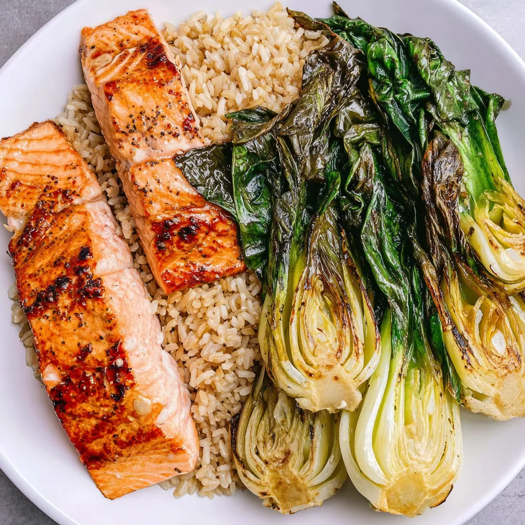 A plate of food with fish, rice, and vegetables.
