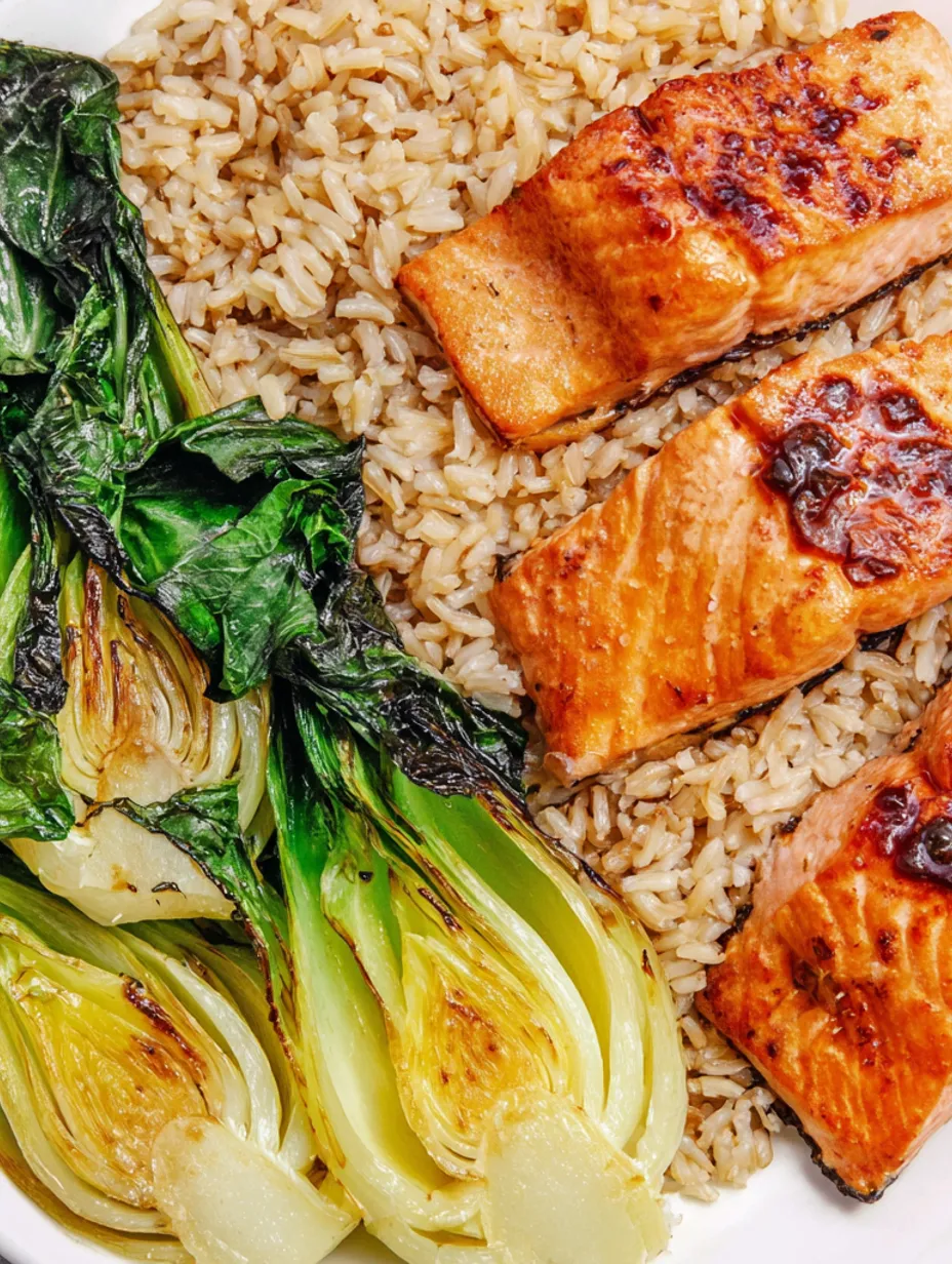 A dish of cooked salmon, rice and bok choy.