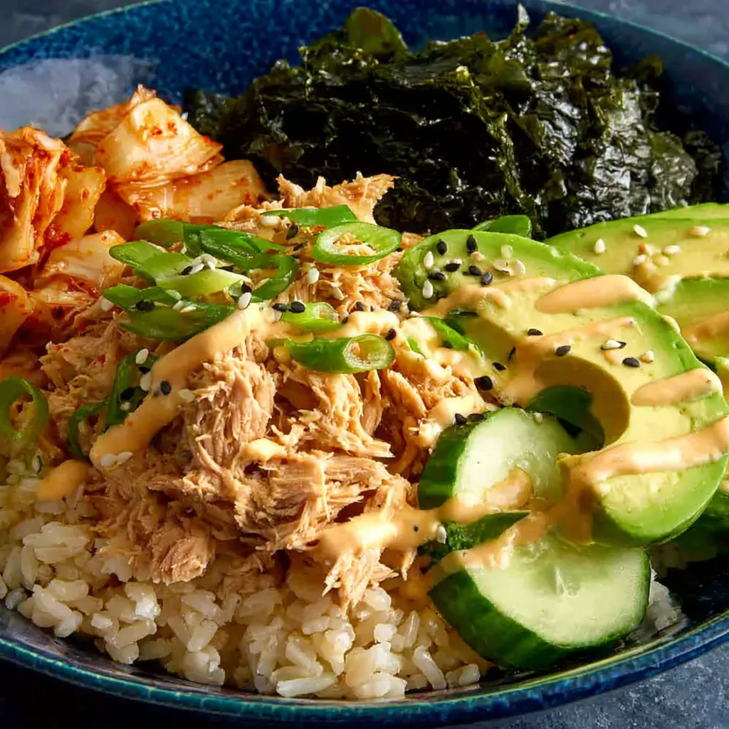A bowl of rice and vegetables with a can of tuna.