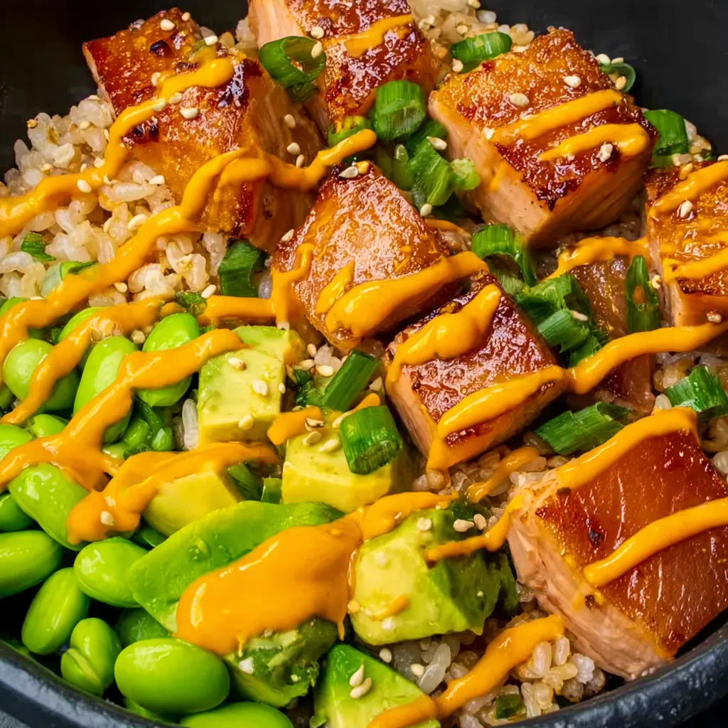 A bowl of rice with salmon and avocado.