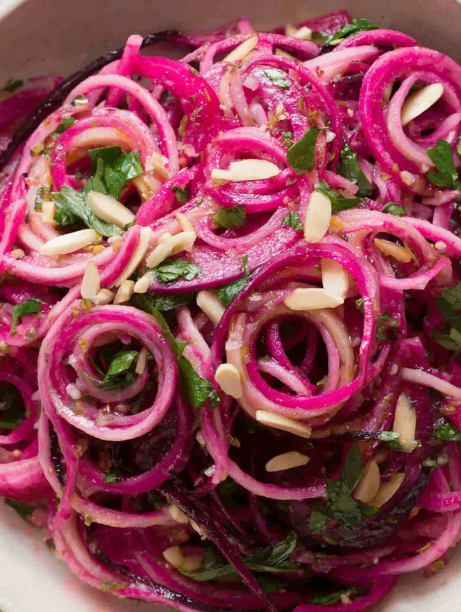 A salad with purple beets and almonds.