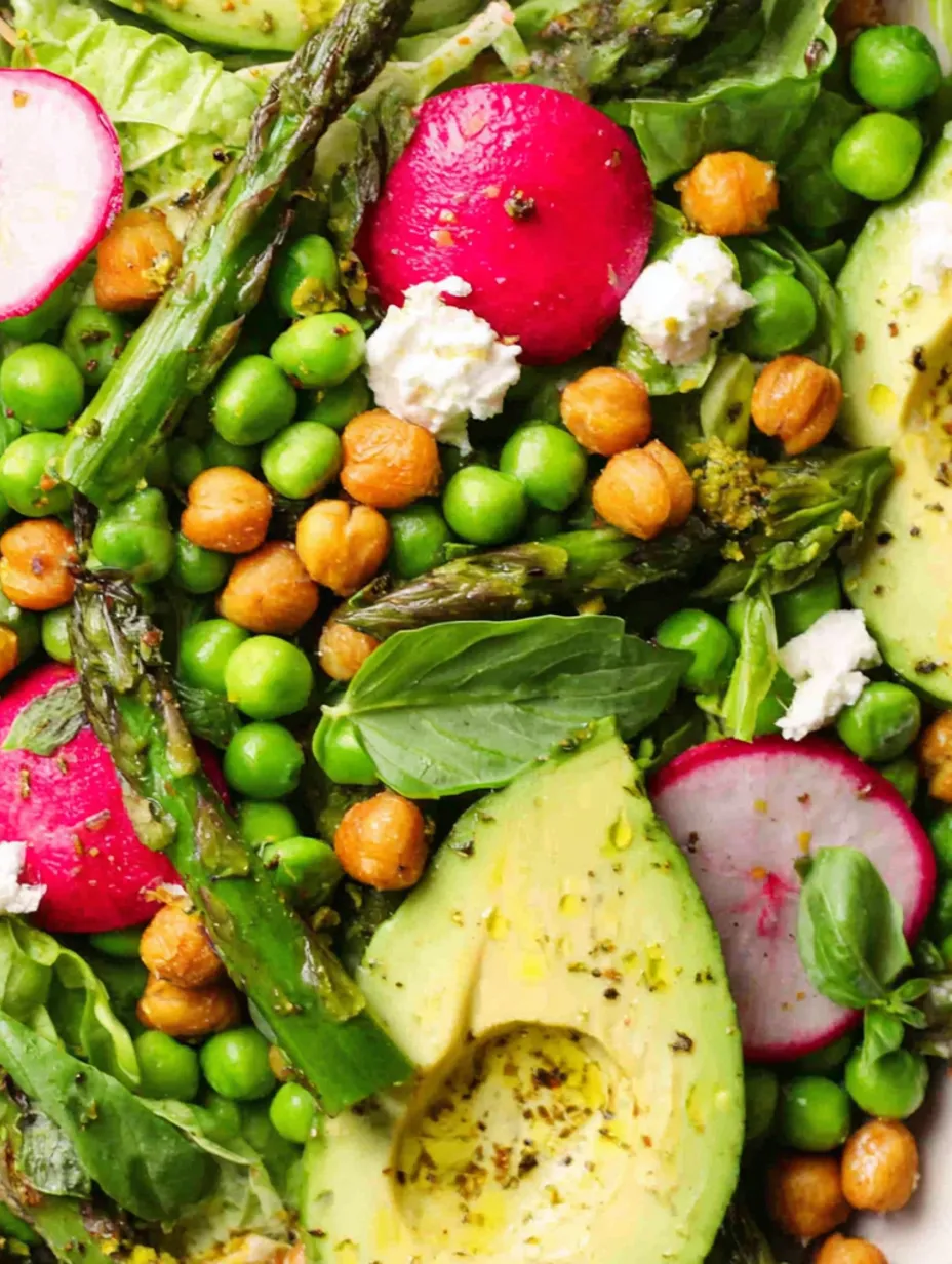 A colorful salad with peas, avocado, and other vegetables.