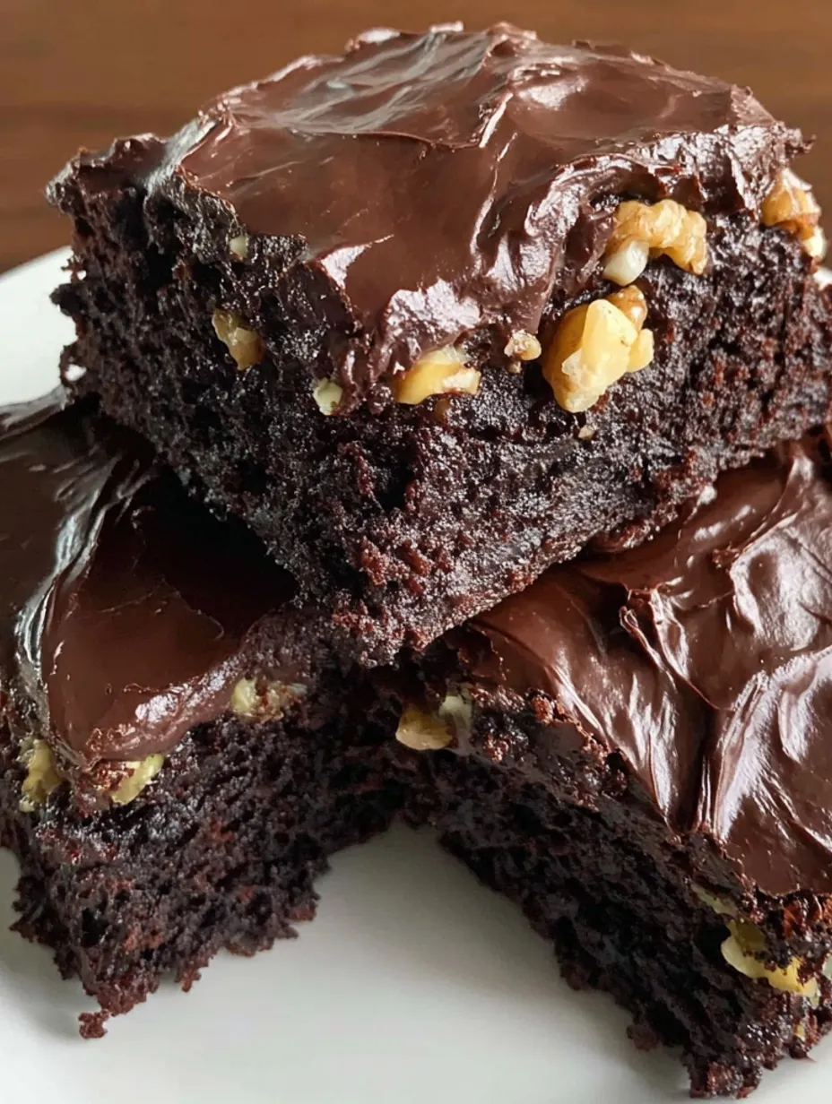 A plate of brownies with nuts on top.