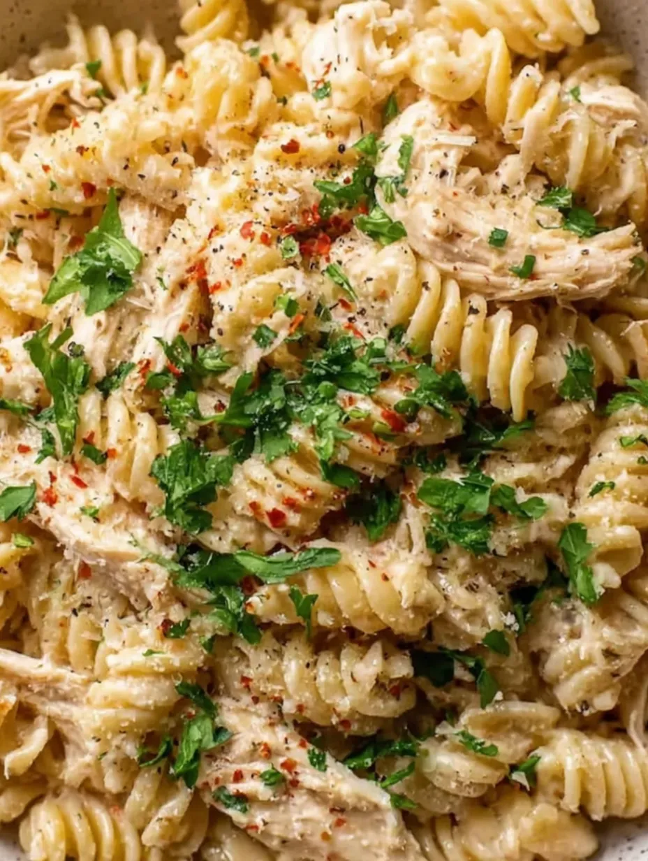 A close up of a delicious pasta dish with chicken and cheese.