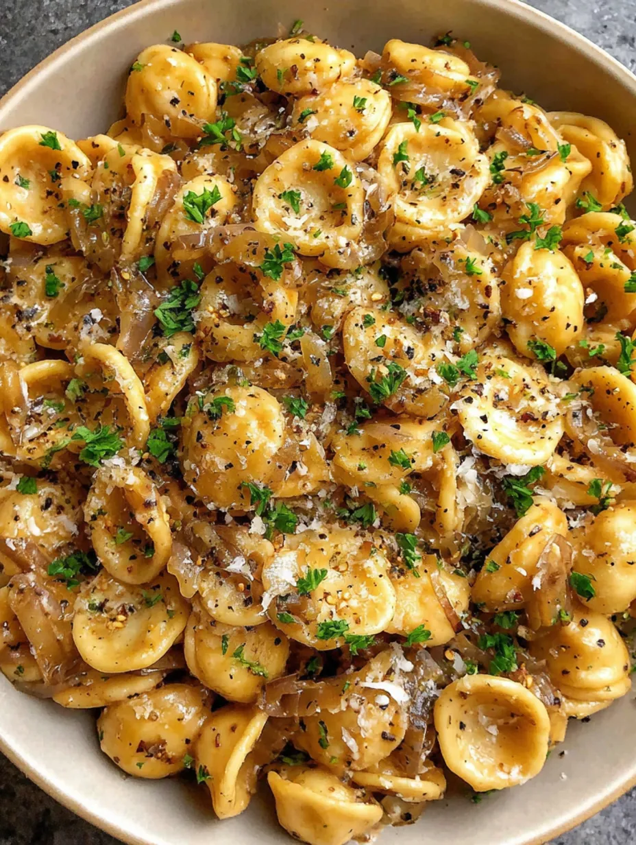 A bowl of pasta with onions and cheese.