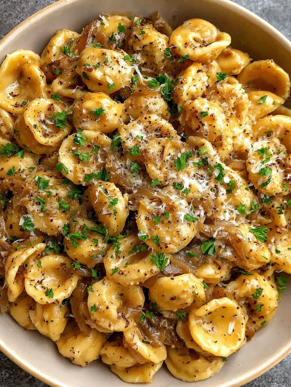 A bowl of pasta with cheese and onions.