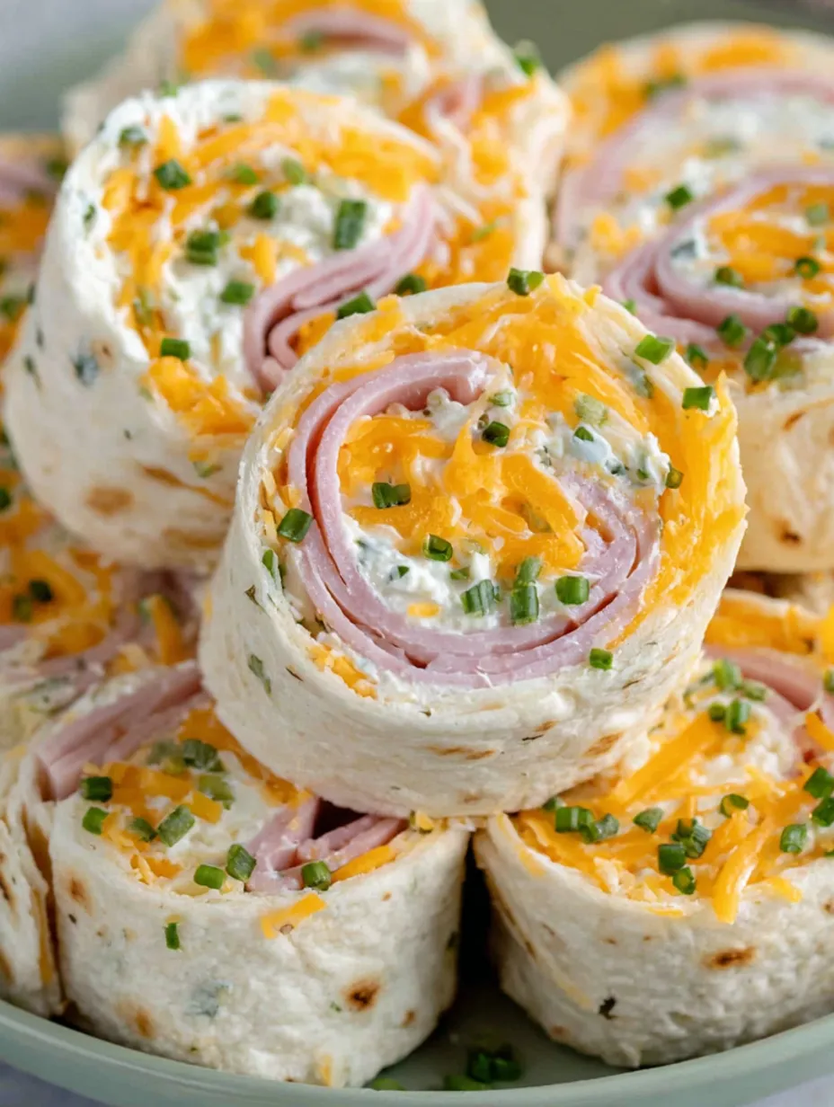 A plate of ham and cheese tortilla rollups.