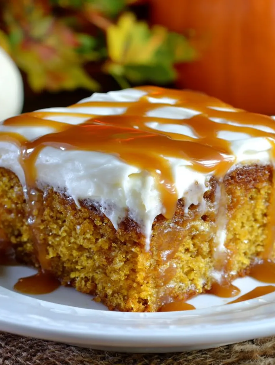 A slice of pumpkin cake with caramel drizzled on top.