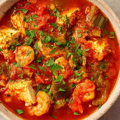 A bowl of shrimp and fish stew.