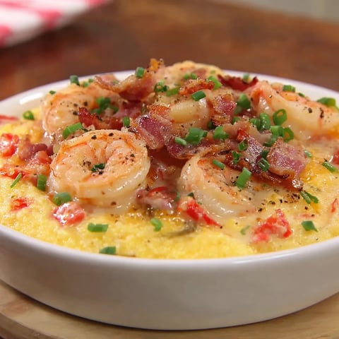 A white bowl filled with shrimp and grits.