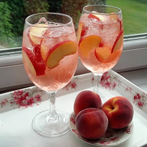 Two glasses of white peach sangria.