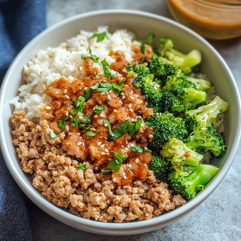 A plate loaded with broccoli, rice, and sauce with a kick.