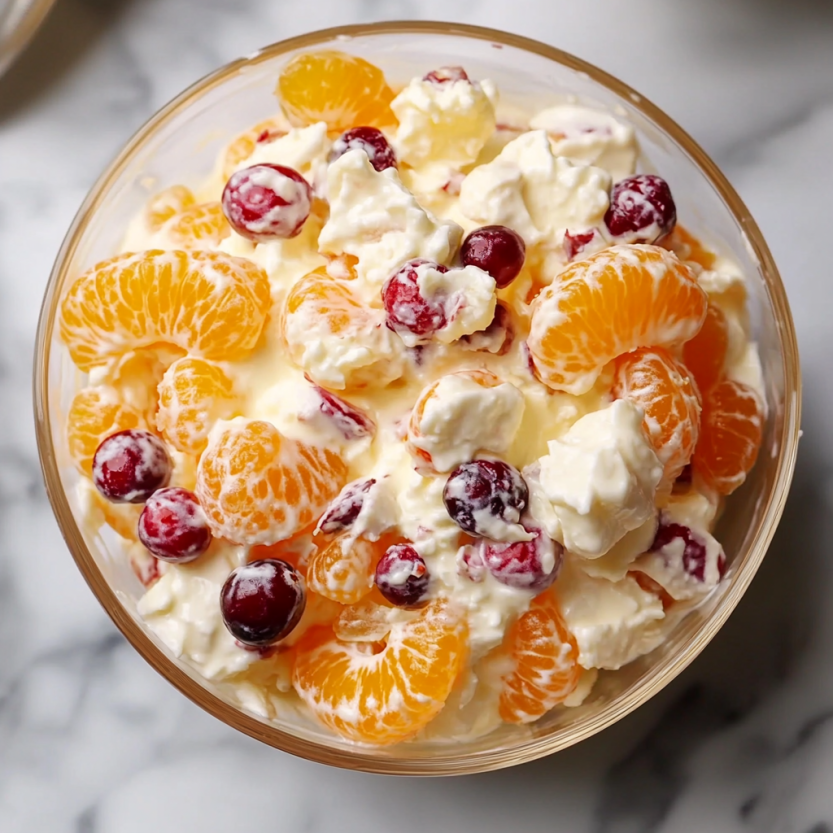 A bowl of fruit and cream.