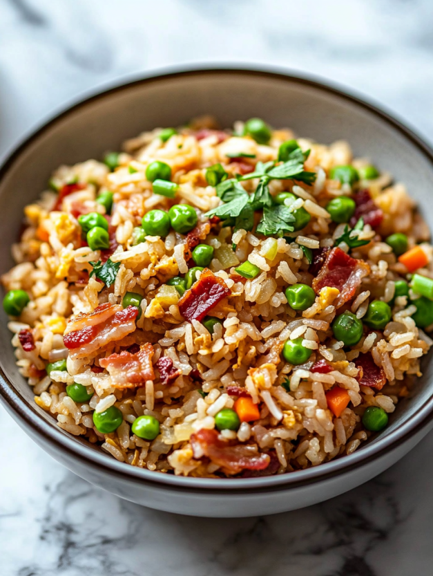A bowl of fried rice with peas and bacon.