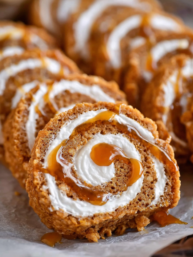 A close up of a caramel pumpkin spice rice krispies treat pinwheel.