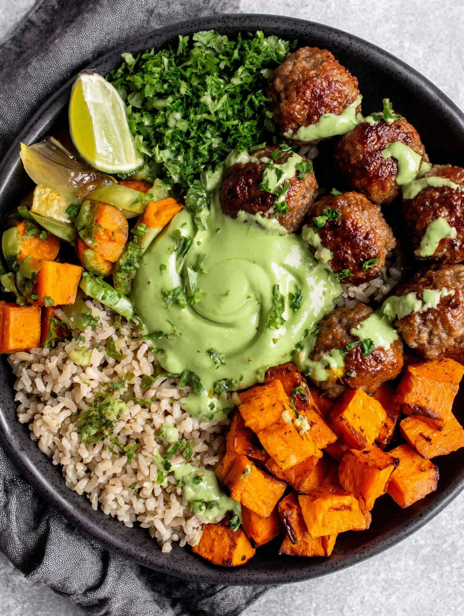 A bowl of meatballs with rice and avocado sauce.