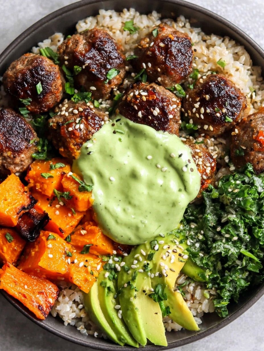 A bowl of meatballs with rice and avocado sauce.