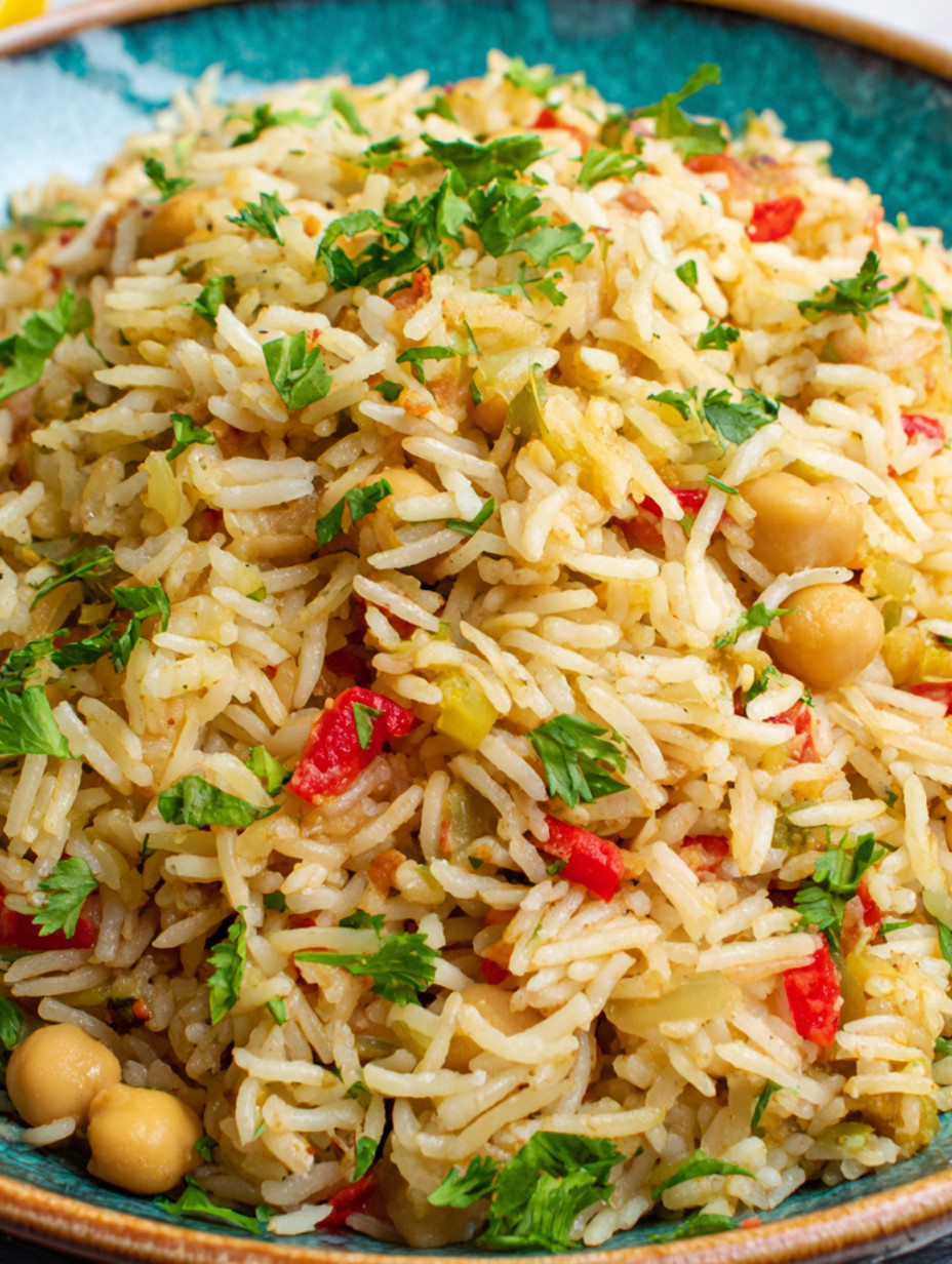 A pile of rice with chickpeas and vegetables.