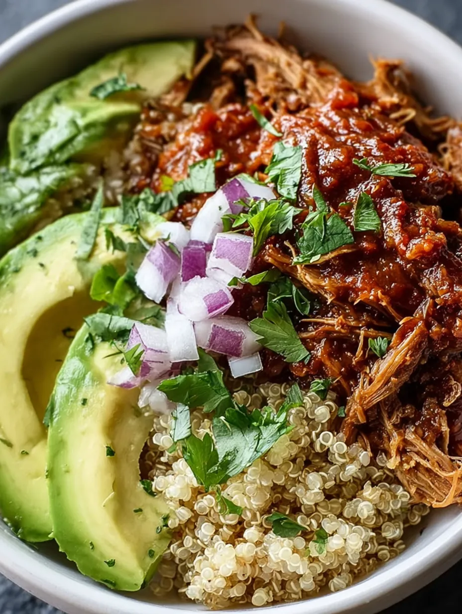 A bowl of pulled pork with onions and peppers.