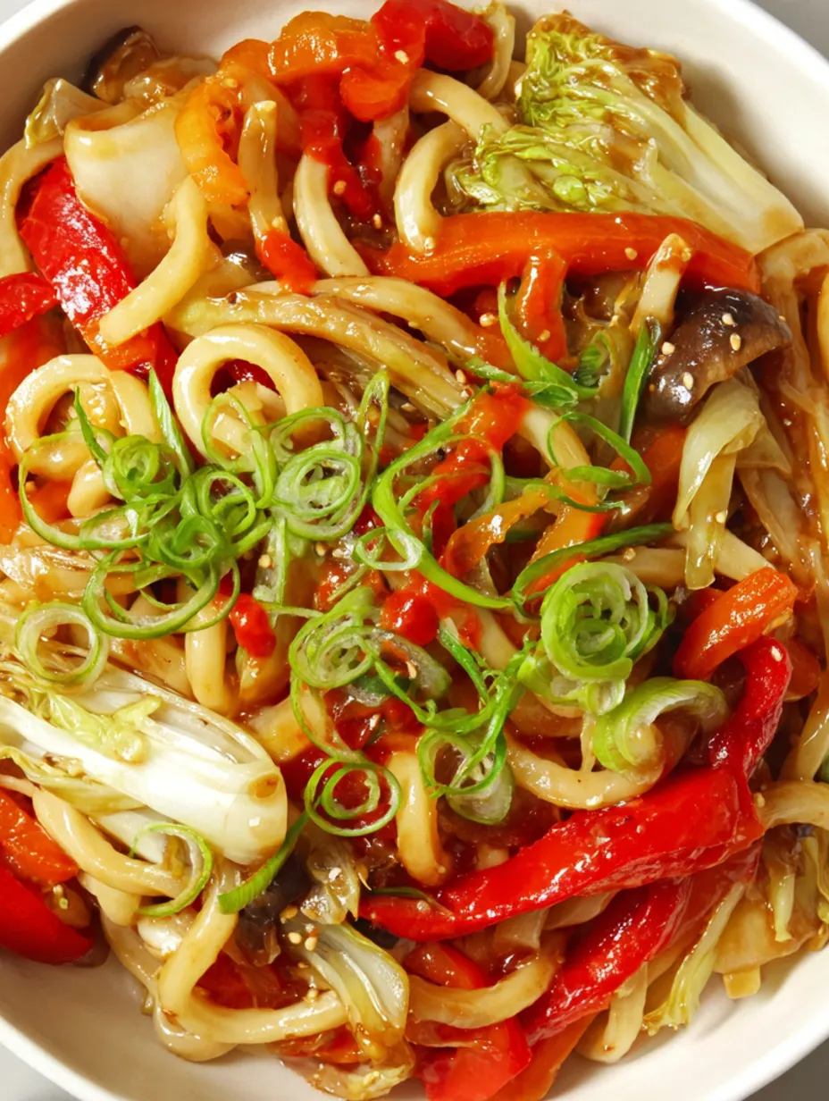 A bowl of stir-fried vegetables and noodles.