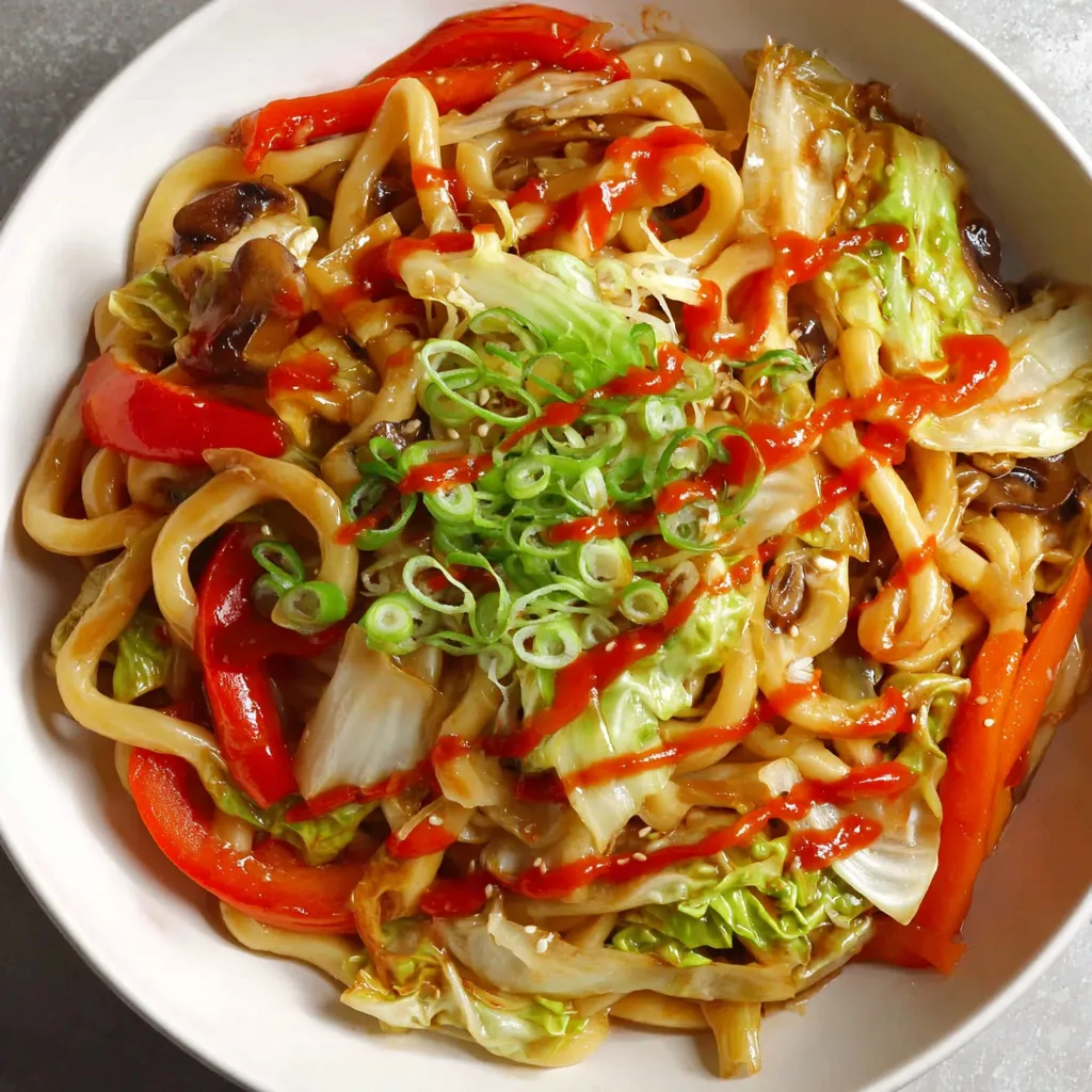 A bowl of stir-fried vegetables with noodles and sauce.