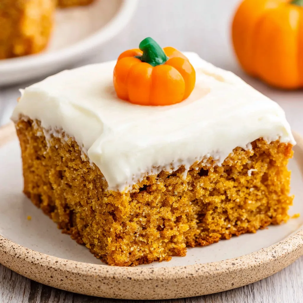 A slice of pumpkin bars with cream cheese frosting.