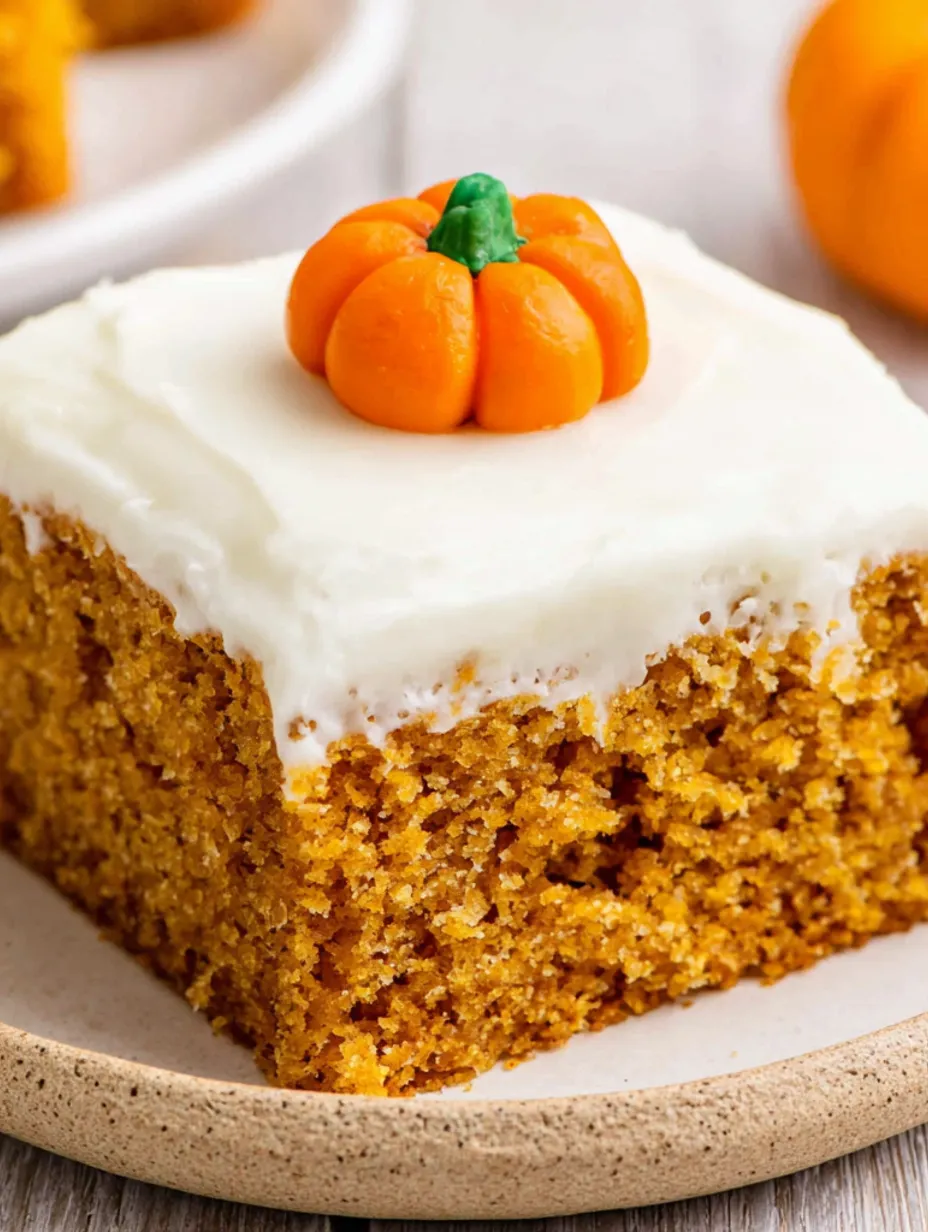 A slice of pumpkin bars with cream cheese frosting.