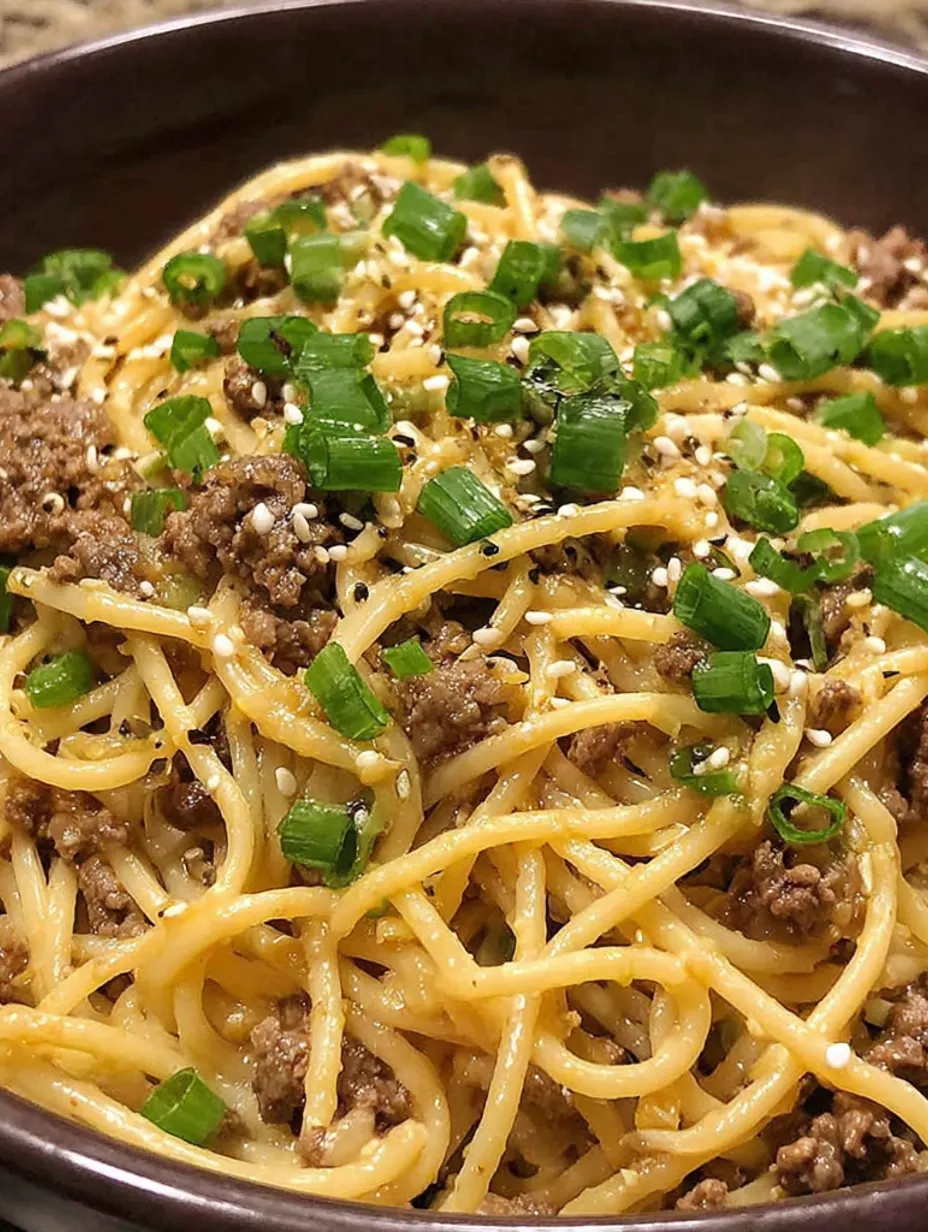 A bowl of noodles with meat and vegetables.
